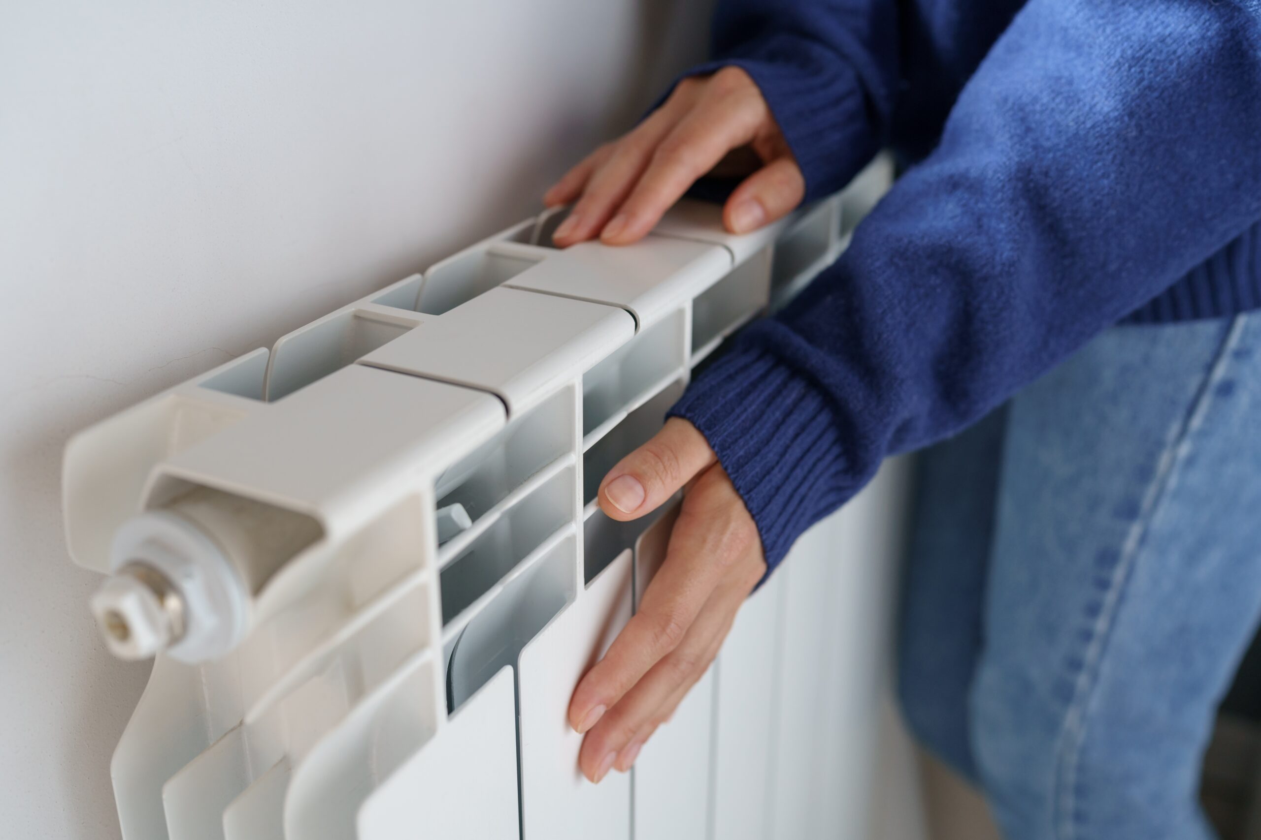 Closeup,Of,Woman,Warming,Her,Hands,On,The,Heater,At